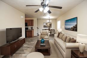 Sioux Falls townhouse for rent - A living room with a television, couch, and a ceiling fan.