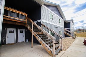 Sioux Falls apartment for rent - A house with a grey siding and a white door is shown.