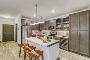 Fort Worth apartment for rent - A kitchen with a white countertop and wooden stools.