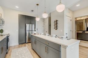 Dallas apartment for rent - A kitchen with a white counter top and a stainless steel refrigerator.