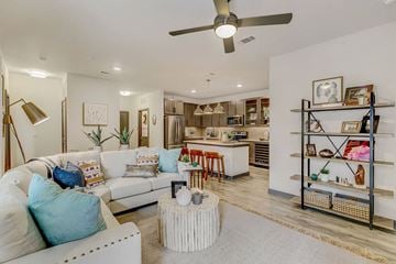 Fort Worth apartment for rent - a living room with a couch and a kitchen in the background