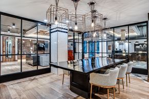 Dallas apartment for rent - A modern dining room with a long table and chairs.