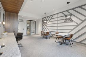Houston apartment for rent - A modern dining room with a white table and chairs.