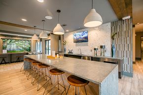 Dallas apartment for rent - A modern kitchen with a long island and bar stools.