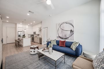 Houston apartment for rent - a living room with a blue couch and a coffee table