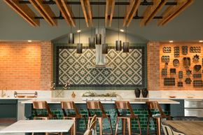 San Antonio apartment for rent - A kitchen with a white counter top and green tiles.