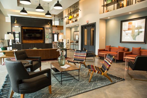 San Antonio apartment for rent - A living room with a black chair and a striped chair.