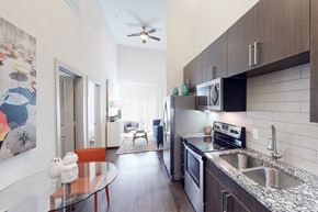 San Antonio apartment for rent - A kitchen with a table and chairs in the middle of the room.