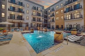 San Antonio apartment for rent - A swimming pool surrounded by apartment buildings.