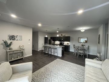Arnold apartment for rent - a renovated living room and kitchen with a dining room table and chairs