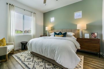 San Tan Valley apartment for rent - A bedroom with a large bed and a window with blinds.