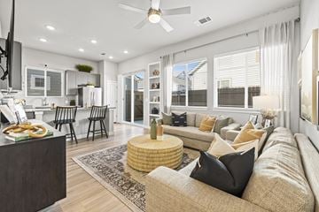 Arlington apartment for rent - A modern living room with a beige sofa and a round wicker coffee table.