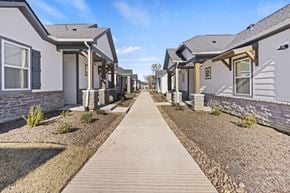 Arlington apartment for rent - A row of houses with a wooden walkway in the foreground at Avilla Lakeridge, Arlington, TX 76002