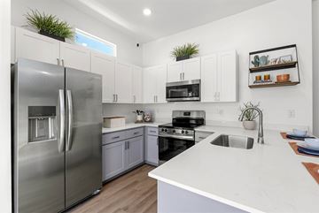 Buckeye apartment for rent - A modern kitchen with a stainless steel refrigerator and white countertops.