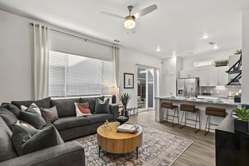 Cleburne apartment for rent - A modern living room with a grey sofa and a wooden coffee table.
