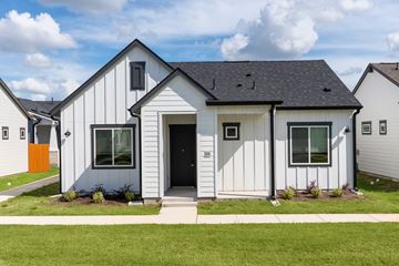 Liberty Hill apartment for rent - A white house with a grey roof and a black door.