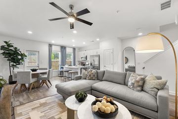 Union City townhouse for rent - A modern living room with a grey sofa and a wooden coffee table.