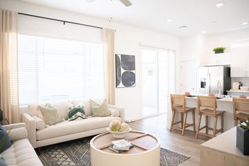 Mcdonough apartment for rent - A modern living room with a white couch and a coffee table.