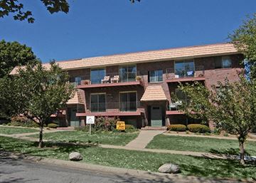 Omaha apartment for rent - an apartment building with a sidewalk in front of it