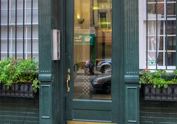 New York apartment for rent - a view of a street through a green door