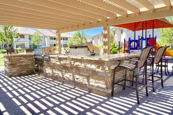 A bar and seating area under a patio