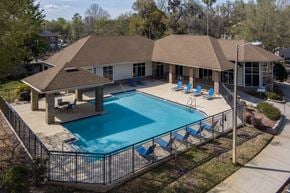 Gainesville apartment for rent - an aerial view of a swimming pool and a house with a pool at Tivoli Apartments, FL, 32608