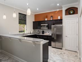Gainesville apartment for rent - a kitchen with stainless steel appliances and granite counter tops at Tivoli Apartments, Florida, 32608