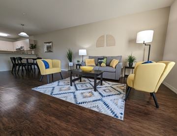 Oviedo apartment for rent - a living room with yellow chairs and a rug