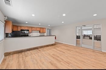 Open living space with kitchen and patio doors