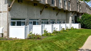 Ground level patios with white privacy fencing