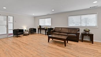 Community lounge with leather seating and wood flooring