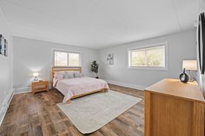 St. Charles apartment for rent - Spacious bedroom with wood style flooring and area rug at Fox Run Apartments, St. Charles, IL