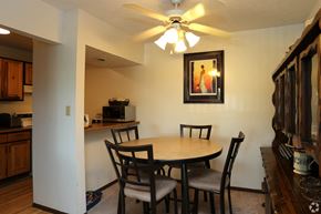 Cincinnati apartment for rent - a dining area with a table and chairs and a ceiling fan