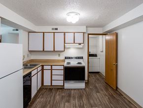 Batavia apartment for rent - an empty kitchen with white appliances and wood floors