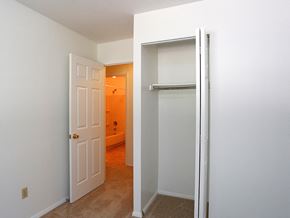 Cincinnati apartment for rent - an empty bedroom with a closet and a door open to a bathroom
