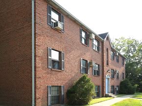 Loveland apartment for rent - a red brick building with windows and a sidewalk