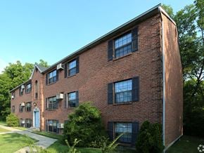 Loveland apartment for rent - a red brick building with windows and a sidewalk