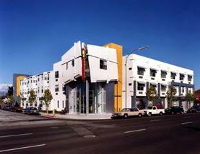 San Jose apartment for rent - A white building with a yellow and red accent on the side.