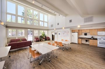 Campbell apartment for rent - A large open plan living and kitchen area with a dining table and chairs.