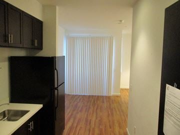 Sunnyvale apartment for rent - A kitchen with black cabinets and a black refrigerator.