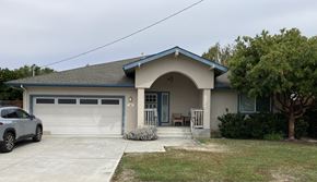 San Jose apartment for rent - A house with a blue garage door and a grey car parked in front.