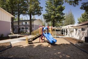 Campbell apartment for rent - A playground with a blue slide and yellow railing.