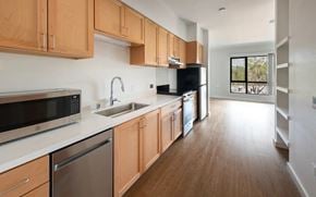 San Jose apartment for rent - A kitchen with wooden cabinets and stainless steel appliances.