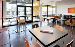San Jose apartment for rent - A room with tables and chairs and a book on one of the tables.