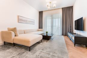 San Jose apartment for rent - A living room with a sofa, coffee table, and television.