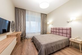 San Jose apartment for rent - A bedroom with a bed, a desk, and a TV.