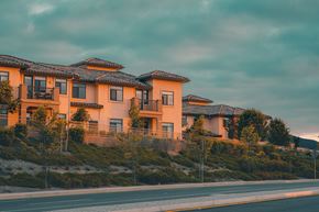 San Jose apartment for rent - A row of houses with orange walls and black roofs.