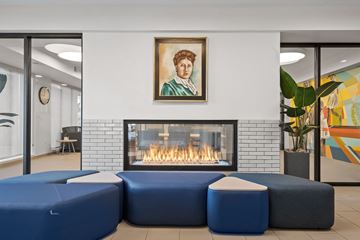 Hopkins apartment for rent - a living room with blue couches and a fireplace