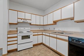 Minneapolis apartment for rent - a kitchen with white cabinets and a stove and a sink