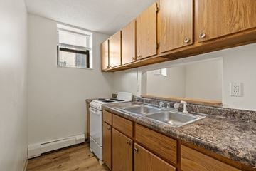 Minneapolis apartment for rent - a kitchen with a sink and a stove and a window